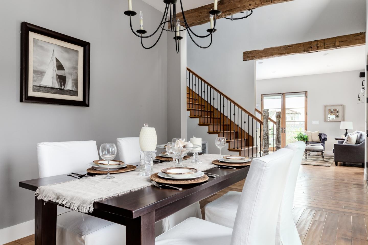3430 Merrill Road Aptos, CA 95003 - Photo 22 of 49 a view of a dining room and livingroom with furniture wooden floor a rug and a chandelier