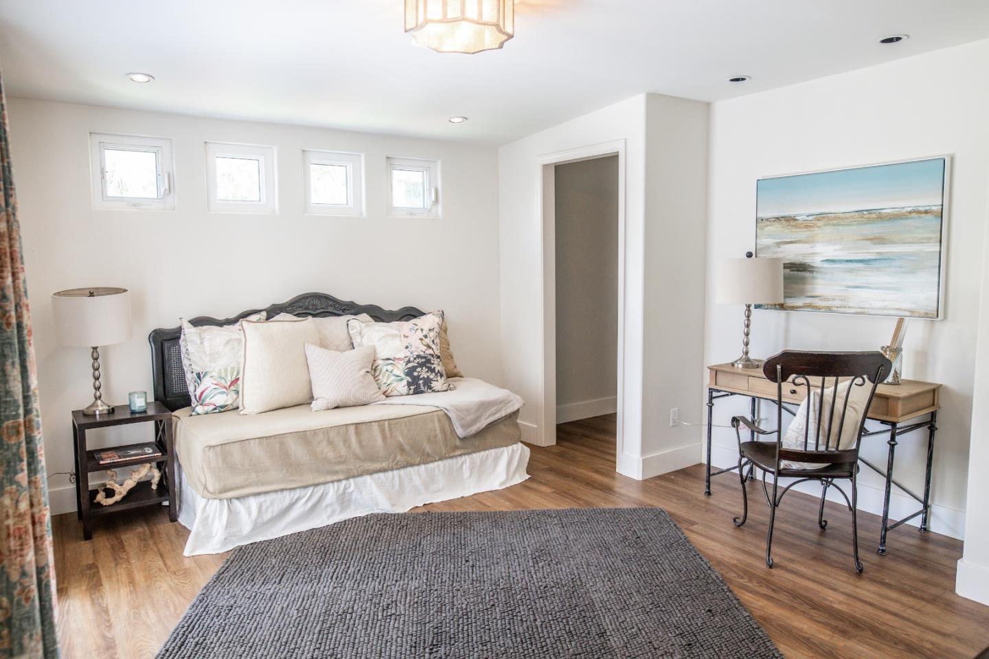 3430 Merrill Road Aptos, CA 95003 - Photo 36 of 49 a spacious bedroom with a bed and a chair