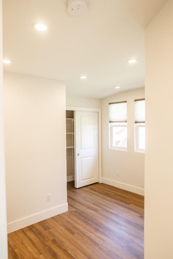 3430 Merrill Road Aptos, CA 95003 - Photo 45 of 49 an empty room with wooden floor and windows