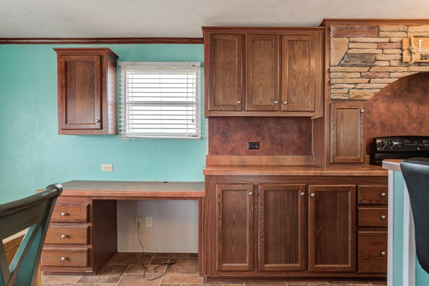 2446 Turkey Ridge Justiceburg, TX 79330 - Photo 17 of 50 a kitchen with cabinets and a wooden floor