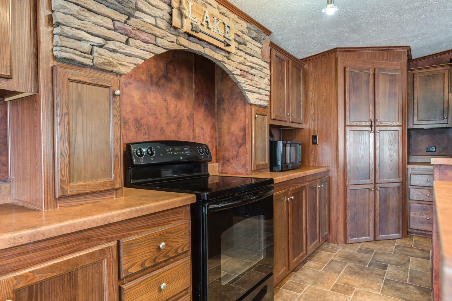 2446 Turkey Ridge Justiceburg, TX 79330 - Photo 18 of 50 a kitchen with stainless steel appliances granite countertop a stove a refrigerator and a cabinets