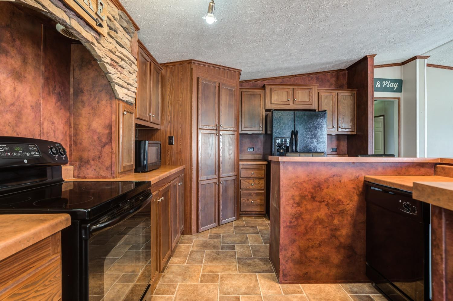 2446 Turkey Ridge Justiceburg, TX 79330 - Photo 19 of 50 a kitchen with stainless steel appliances granite countertop a refrigerator a stove and a sink