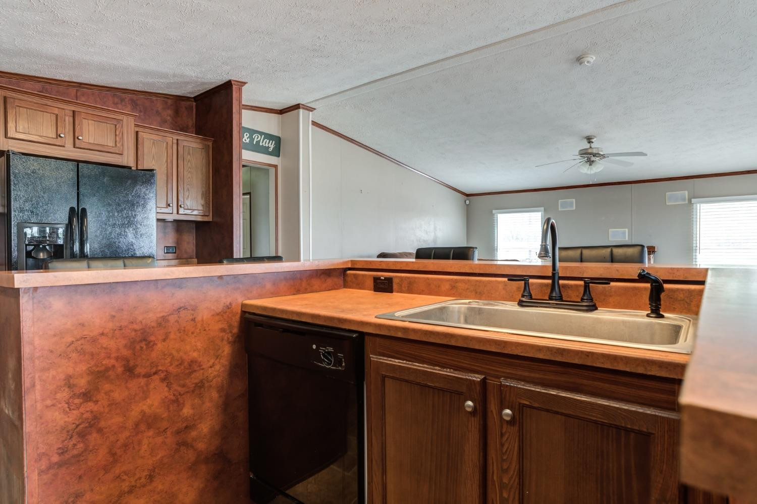 2446 Turkey Ridge Justiceburg, TX 79330 - Photo 20 of 50 a utility room with a sink and a refrigerator