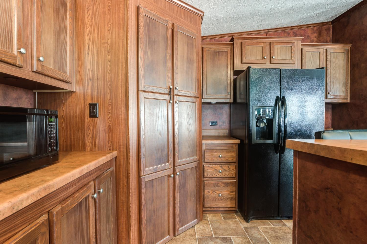 2446 Turkey Ridge Justiceburg, TX 79330 - Photo 21 of 50 a kitchen with stainless steel appliances granite countertop a refrigerator and a stove