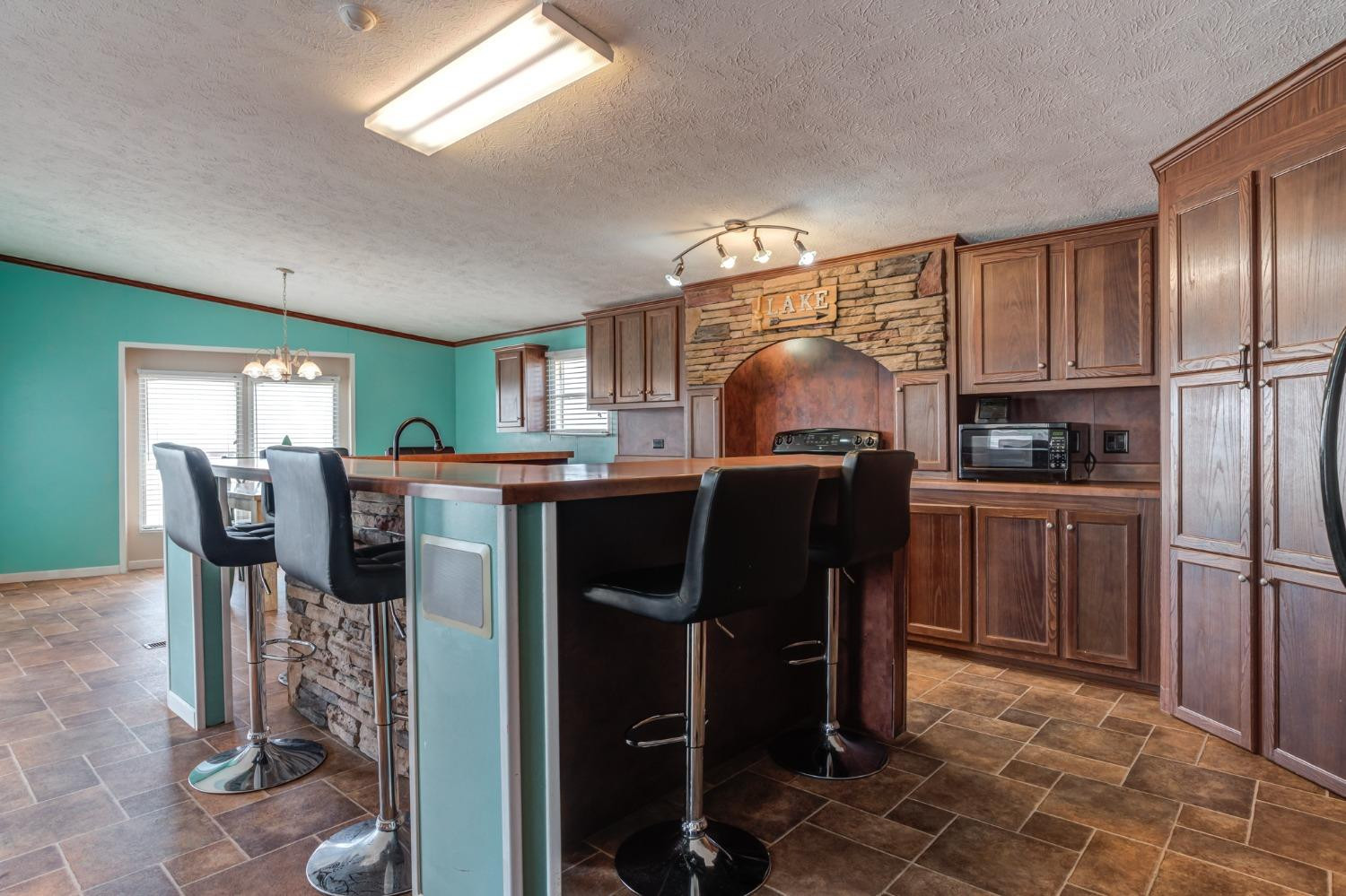 2446 Turkey Ridge Justiceburg, TX 79330 - Photo 24 of 50 a view of kitchen with refrigerator cabinets and outdoor seating