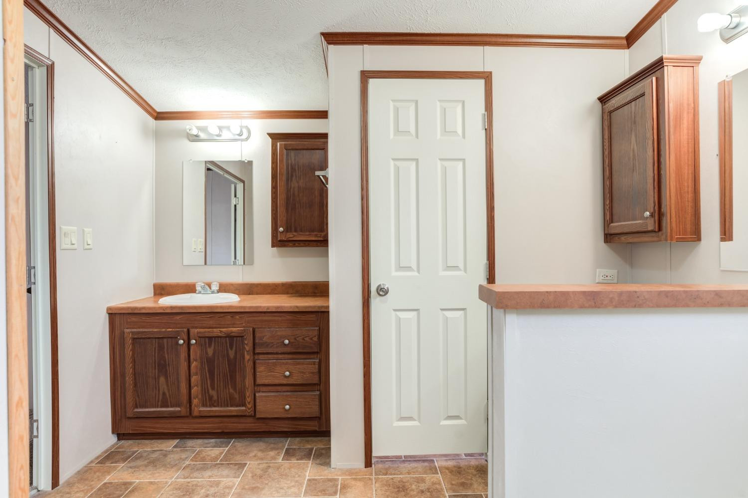 2446 Turkey Ridge Justiceburg, TX 79330 - Photo 34 of 50 a bathroom with a granite countertop sink and a mirror