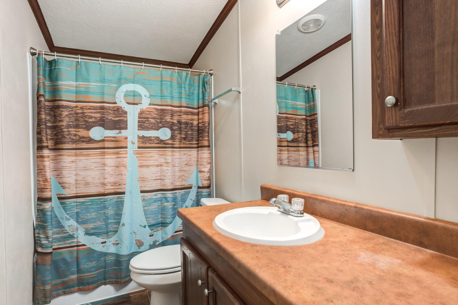 2446 Turkey Ridge Justiceburg, TX 79330 - Photo 37 of 50 a bathroom with a sink toilet and shower