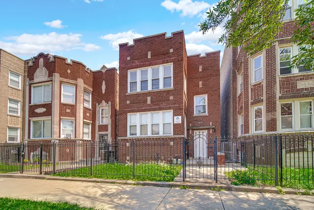 front view of a brick house with a yard