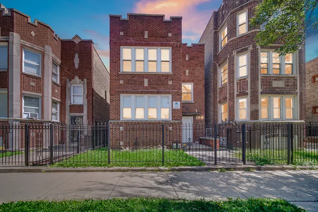 a view of a brick building next to a yard