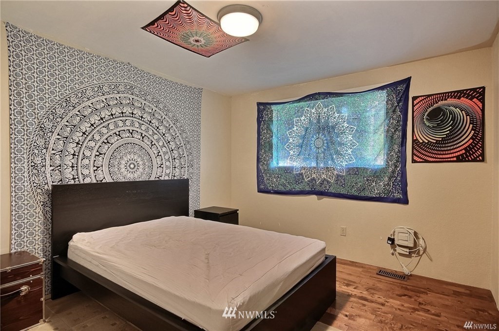508 228th Street Southeast Bothell, WA 98021 - Photo 11 of 22 a bedroom with a bed and a painting on the wall