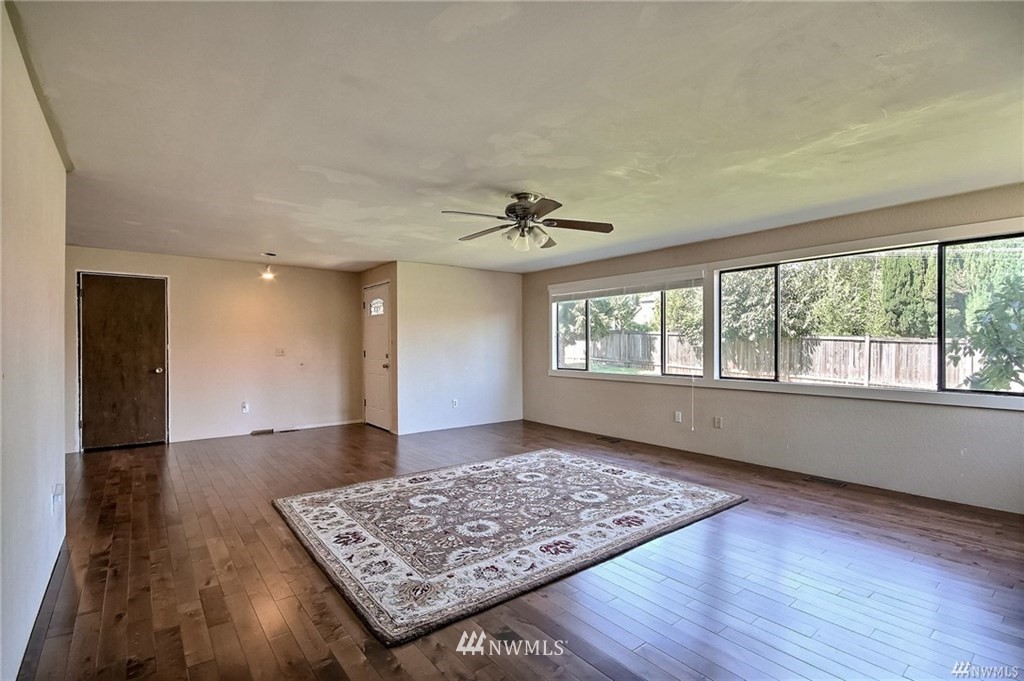 508 228th Street Southeast Bothell, WA 98021 - Photo 7 of 22 an empty room with wooden floor and windows