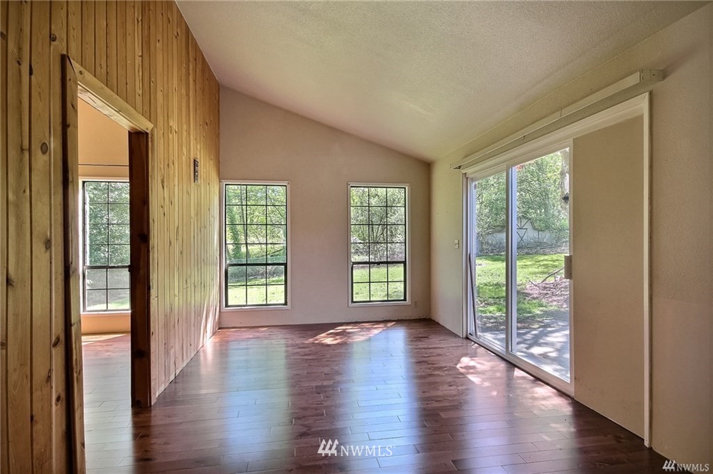 508 228th Street Southeast Bothell, WA 98021 - Photo 8 of 22 a view of an empty room with wooden floor and a window