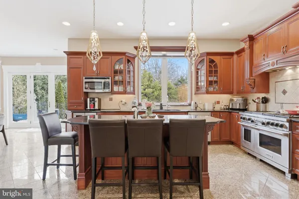 a large kitchen with a table and chairs