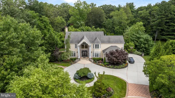 a aerial view of a house with yard and green space