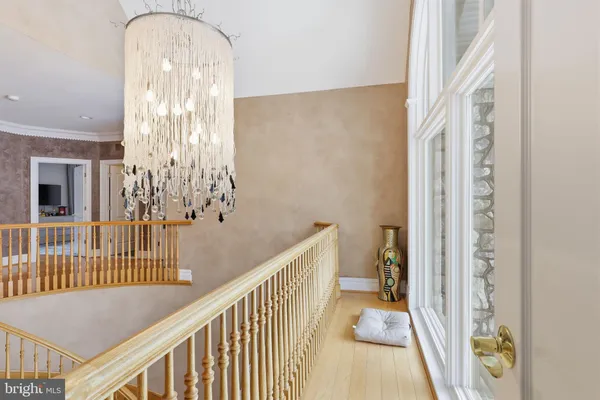 a spacious bedroom with a large bed and a chandelier