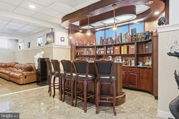 a front view of a house with a tree