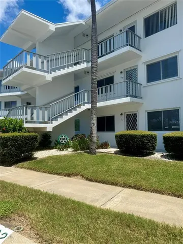 a front view of a house with a yard and plants