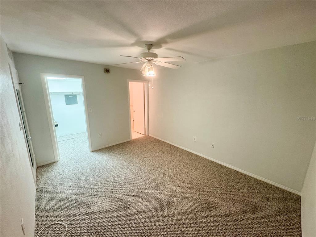 11201 80th Avenue, Unit 101 Seminole, FL 33772 - Photo 16 of 31 an empty room with windows and fan