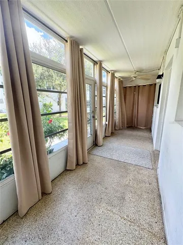 a view of hallway with furniture and a window