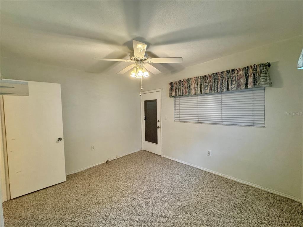 11201 80th Avenue, Unit 101 Seminole, FL 33772 - Photo 25 of 31 an empty room with windows and fan