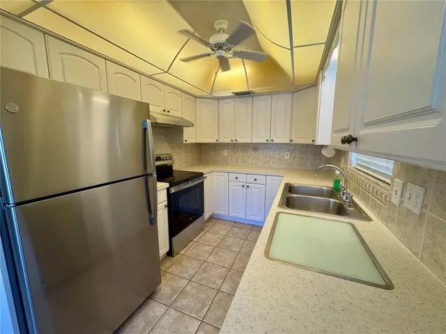 a kitchen with a sink cabinets and window