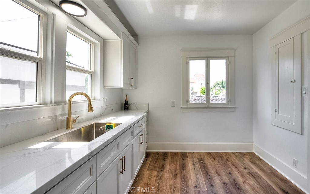 3222 Locust Street Riverside, CA 92501 - Photo 11 of 35 a kitchen with a sink cabinets a stove and a window