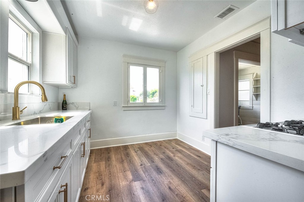 3222 Locust Street Riverside, CA 92501 - Photo 12 of 35 a kitchen with wooden floors and sink