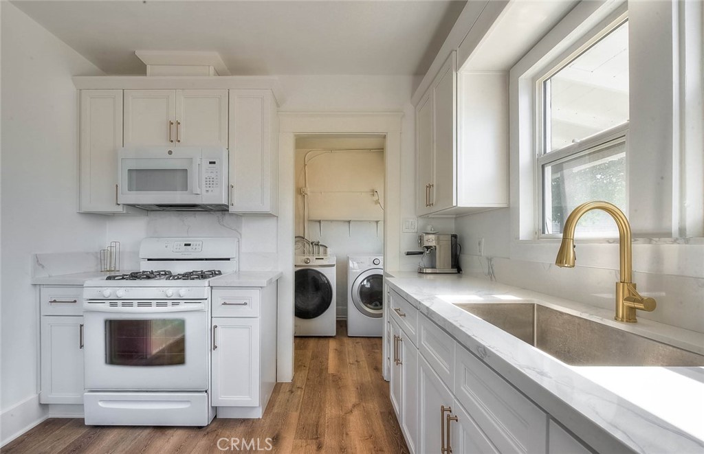 3222 Locust Street Riverside, CA 92501 - Photo 8 of 35 a kitchen with white cabinets and white appliances