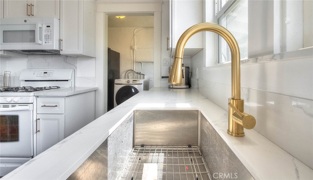 3222 Locust Street Riverside, CA 92501 - Photo 10 of 35 a kitchen with a refrigerator and a stove top oven