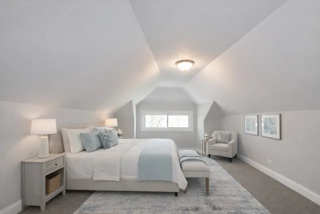 a spacious bedroom with a bed and a large window