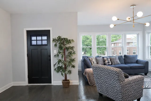 a living room with furniture and a potted plant