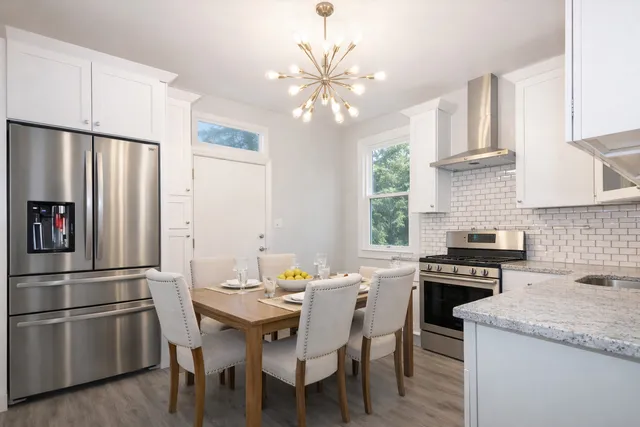 a kitchen with a table chairs stove and refrigerator