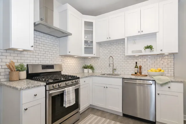 a kitchen with granite countertop a sink stove and cabinets