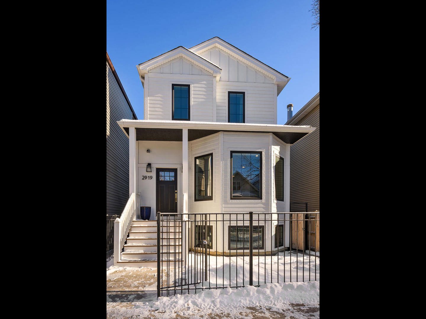 a view of a white house with large windows