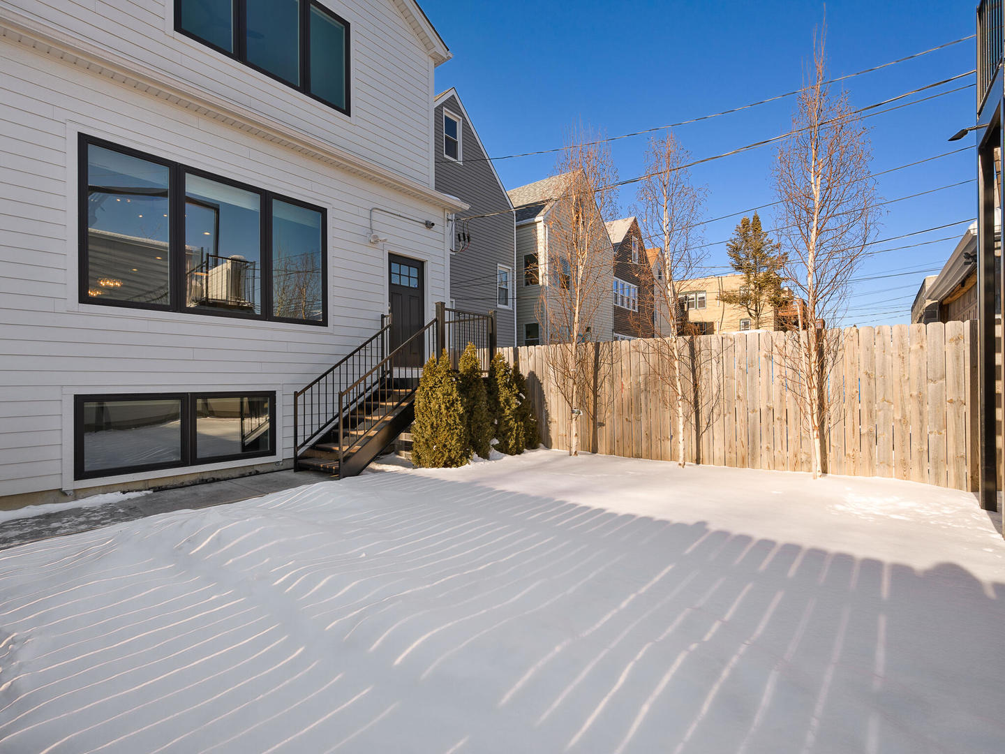 2919 North Dawson Avenue Chicago, IL 60618 - Photo 33 of 38 a view of a house with a wooden fence