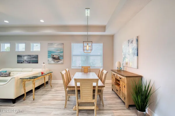 a dining room with furniture and wooden floor