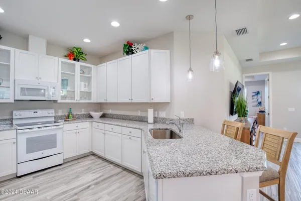 a view of a kitchen with electric appliances