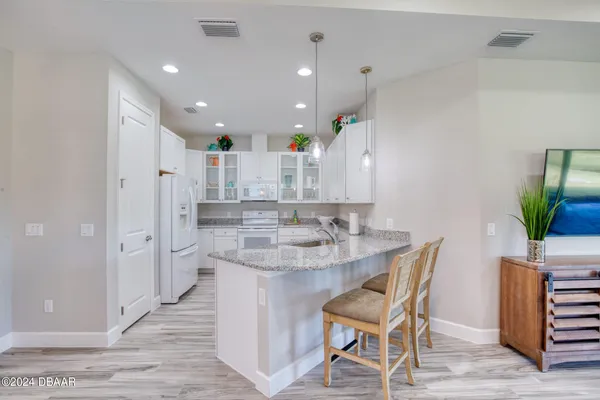 a kitchen with kitchen island cabinets and wooden floor