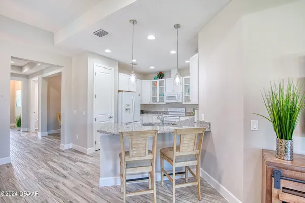 a kitchen with kitchen island wooden cabinets and counter space