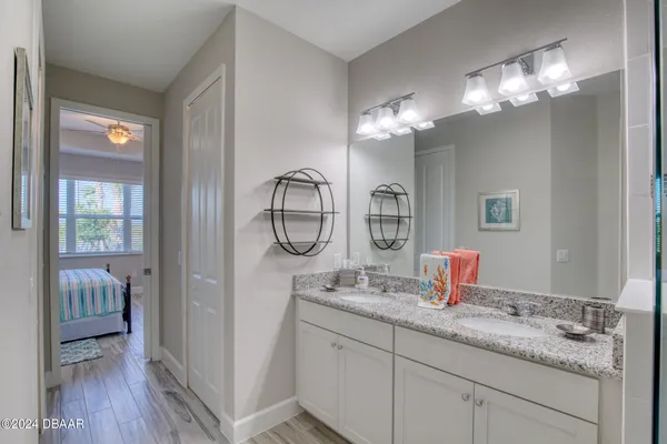 a bathroom with a granite countertop shower a sink and a mirror