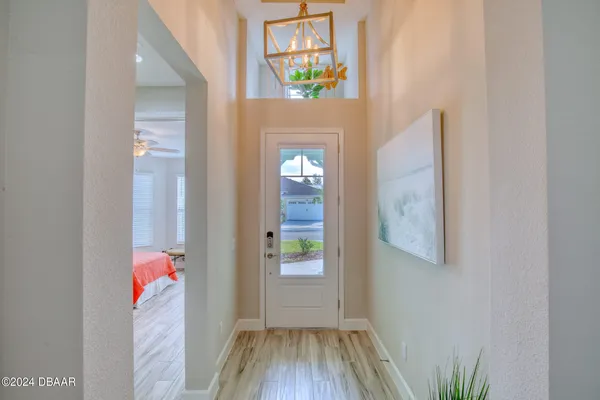 a view of a hallway view with wooden floor and entryway