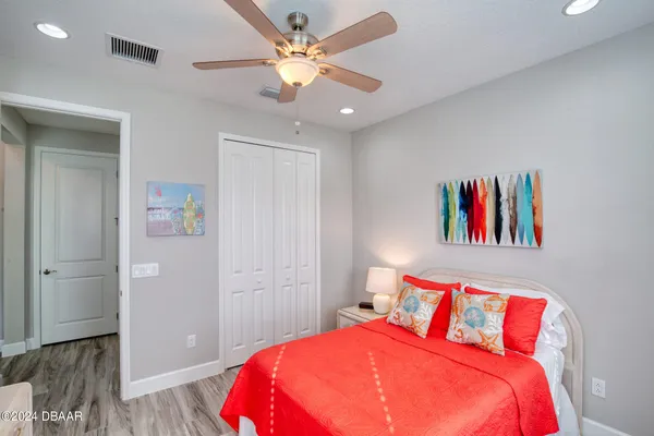 a bedroom with a large bed and a chandelier