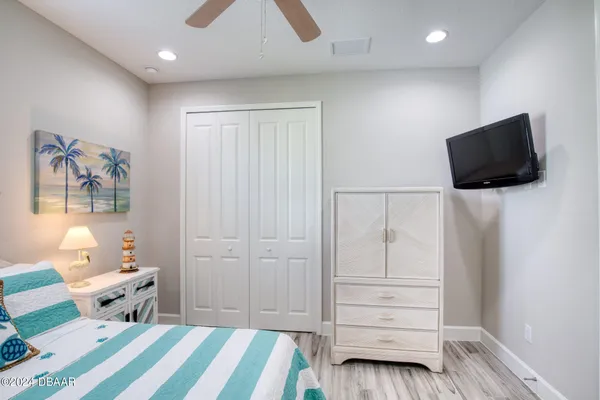 a bedroom with a bed and a flat screen tv