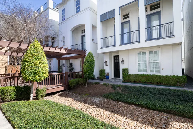 a front view of a house with a garden and plants