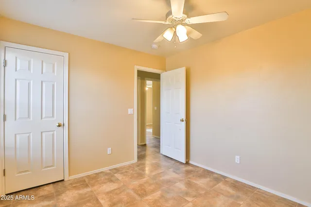 a view of an empty room with a fan