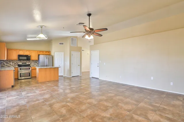 a view of a kitchen with a stove and cabinets