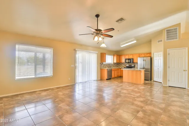 a view of an empty room with a kitchen
