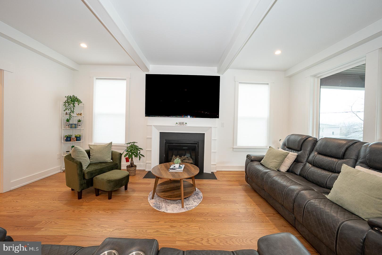 217 Namar Avenue Exton, PA 19341 - Photo 13 of 85 a living room with furniture a flat screen tv and a fireplace