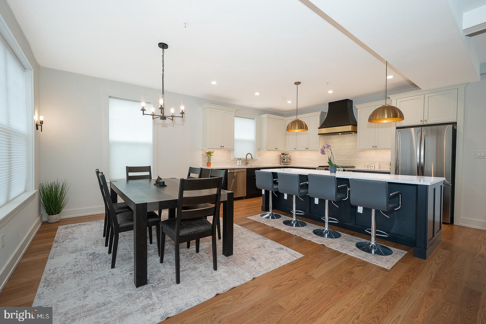 217 Namar Avenue Exton, PA 19341 - Photo 20 of 85 a kitchen with stainless steel appliances kitchen island granite countertop a table chairs and a refrigerator