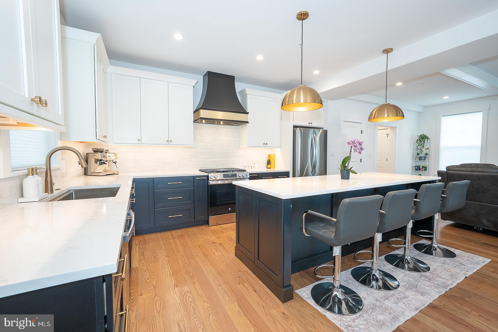 217 Namar Avenue Exton, PA 19341 - Photo 22 of 85 a kitchen with kitchen island granite countertop a sink a stove and a wooden floors
